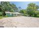 Charming ranch-style home with a painted brick facade, a front porch with wooden railings, and a spacious concrete parking area at 4806 Rockbridge Rd, Stone Mountain, GA 30083