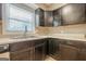Close up of kitchen with cabinets, sink, and window with blind at 4806 Rockbridge Rd, Stone Mountain, GA 30083