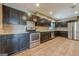 Kitchen features stainless steel appliances, dark cabinetry, and hard surface floors at 4806 Rockbridge Rd, Stone Mountain, GA 30083
