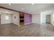 A large room with white walls, wood-look floors and recessed lighting at 4806 Rockbridge Rd, Stone Mountain, GA 30083
