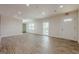 A spacious room with wood-look floors, white walls and multiple windows at 4806 Rockbridge Rd, Stone Mountain, GA 30083
