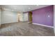 Spacious living room with hard surface floors and purple accent wall at 4806 Rockbridge Rd, Stone Mountain, GA 30083