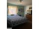 Bedroom with patterned bedspread, dresser with television, and neutral wall art at 79 Peyton Sw Pl, Atlanta, GA 30311