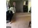 Living room with a dark futon, studio equipment, and carpeted floor at 79 Peyton Sw Pl, Atlanta, GA 30311