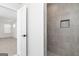 Bathroom features tiled shower with shampoo niche and open door to bedroom at 412 Cantrell Drive, Dallas, GA 30157