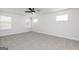 A bright and airy bedroom with neutral walls, carpet flooring, three windows and ceiling fan at 412 Cantrell Drive, Dallas, GA 30157