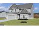 Charming two-story home featuring a two-car garage and a well-manicured lawn at 412 Cantrell Drive, Dallas, GA 30157