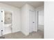 Upstairs hallway leading to bathroom and bedroom; showcasing neutral colors, carpet flooring, and white trim at 412 Cantrell Drive, Dallas, GA 30157