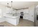 Modern kitchen with island, white cabinets, stainless steel appliances, and stylish pendant lighting at 412 Cantrell Drive, Dallas, GA 30157
