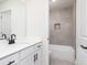 Bathroom boasts a neutral tile shower, white vanity with quartz countertop, and modern fixtures at 446 Cantrell Drive, Dallas, GA 30157