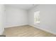 Cozy bedroom showcasing wood-look flooring, neutral walls, and a bright window at 446 Cantrell Drive, Dallas, GA 30157