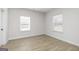 Bedroom with two windows, light walls, and laminate wood flooring at 446 Cantrell Drive, Dallas, GA 30157