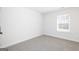 Bright bedroom features neutral carpet, white walls and trim, and a window for natural light at 446 Cantrell Drive, Dallas, GA 30157