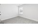Bedroom featuring neutral carpet, white walls and trim, with a window to let in natural light at 446 Cantrell Drive, Dallas, GA 30157