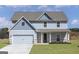 Charming two-story home with a light blue exterior, attached garage, and well-manicured front lawn at 446 Cantrell Drive, Dallas, GA 30157