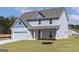 Beautiful two-story home featuring a light blue exterior, inviting front porch, and newly installed lawn at 446 Cantrell Drive, Dallas, GA 30157