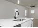 Kitchen island with sink, quartz countertops, and stainless steel appliances in view at 446 Cantrell Drive, Dallas, GA 30157