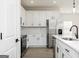 New kitchen featuring stainless steel appliances, island, quartz countertops, and white cabinets at 446 Cantrell Drive, Dallas, GA 30157