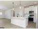 Open concept kitchen with island, pendant lights, stainless steel appliances, and white cabinets at 446 Cantrell Drive, Dallas, GA 30157