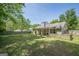 View of the backyard featuring green grass, fenced yard, patio with a covered area at 5045 Edinborough Pl, Sugar Hill, GA 30518