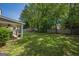 View of the backyard featuring green grass, fenced yard, patio with a covered area at 5045 Edinborough Pl, Sugar Hill, GA 30518
