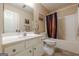 Bathroom featuring a white vanity, toilet, and tub with shower and shower curtain at 5045 Edinborough Pl, Sugar Hill, GA 30518