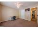 Bedroom with beige walls, carpeted floor, ceiling fan with lights, desk and TV at 5045 Edinborough Pl, Sugar Hill, GA 30518