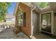 Inviting front entrance showcasing a brick facade, large window, and a covered entryway for guests at 5045 Edinborough Pl, Sugar Hill, GA 30518