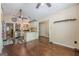 Kitchen and dining area featuring hardwood floors, a breakfast bar, white cabinets, and stainless steel appliances at 5045 Edinborough Pl, Sugar Hill, GA 30518