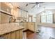 Spacious kitchen with granite countertops, farmhouse sink, and an open layout leading to the dining area at 5045 Edinborough Pl, Sugar Hill, GA 30518