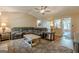 Inviting living room featuring a large sectional, wood coffee table, and a view into the adjacent kitchen at 5045 Edinborough Pl, Sugar Hill, GA 30518
