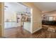 Open-concept living room and kitchen featuring hardwood floors, neutral walls, and a view of a comfortable living space at 5045 Edinborough Pl, Sugar Hill, GA 30518
