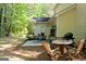 Backyard patio with various seating arrangements, grill, and wooded view at 140 Braymoor Cir, Fayetteville, GA 30215