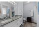 Bathroom featuring dual sinks with granite counters, white cabinets, and updated fixtures at 140 Braymoor Cir, Fayetteville, GA 30215
