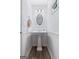 Traditional powder room featuring a pedestal sink, wood floors, and beadboard paneling at 140 Braymoor Cir, Fayetteville, GA 30215