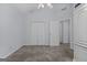 Light-filled bedroom with neutral carpet, closet, and entry doors and vaulted ceiling with ceiling fan at 140 Braymoor Cir, Fayetteville, GA 30215