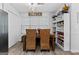 Open dining area features built-in shelving, natural light, and wood flooring at 140 Braymoor Cir, Fayetteville, GA 30215