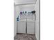 Functional laundry room featuring a full size washer, dryer, and overhead storage at 140 Braymoor Cir, Fayetteville, GA 30215