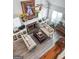 High-angle view of a comfortable living room with a brick fireplace and wood floors at 140 Braymoor Cir, Fayetteville, GA 30215