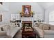 Cozy living room with a charming brick fireplace, bright natural light, and comfortable seating at 140 Braymoor Cir, Fayetteville, GA 30215