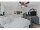 Cozy bedroom features soft lighting, a ceiling fan, and light gray accent furniture at 140 Braymoor Cir, Fayetteville, GA 30215