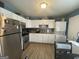 Bright kitchen with stainless steel appliances, white cabinets, and convenient laundry area at 140 Se Mount Zion Rd # 41, Atlanta, GA 30354