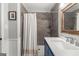 Updated bathroom with tile shower and modern vanity with framed mirror at 75 Mcintosh Estates Dr, Sharpsburg, GA 30277