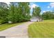 A ranch style home featuring a long driveway, garage, and well maintained lawn at 75 Mcintosh Estates Dr, Sharpsburg, GA 30277