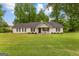 Charming ranch-style home featuring a well-manicured lawn, classic shutters, and a welcoming front porch at 75 Mcintosh Estates Dr, Sharpsburg, GA 30277
