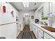 Functional kitchen with white cabinets, wood-look flooring, and a view into the dining area at 75 Mcintosh Estates Dr, Sharpsburg, GA 30277