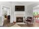 Cozy living room with fireplace, TV, and doorways to other rooms at 75 Mcintosh Estates Dr, Sharpsburg, GA 30277