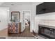 Cozy living room with fireplace, wood floors, and a view into the main bedroom at 75 Mcintosh Estates Dr, Sharpsburg, GA 30277
