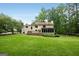 Expansive backyard and exterior home view with a large manicured lawn at 100 Hartford Pl, Fayetteville, GA 30214