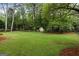 A sprawling backyard featuring a storage shed and lush trees for privacy at 100 Hartford Pl, Fayetteville, GA 30214